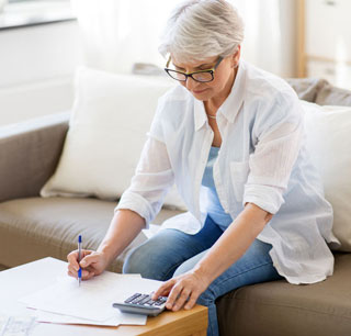 Older woman calculating her taxes